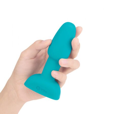 Hand holding the side of the Petite Teal B-Vibe Rimming plug