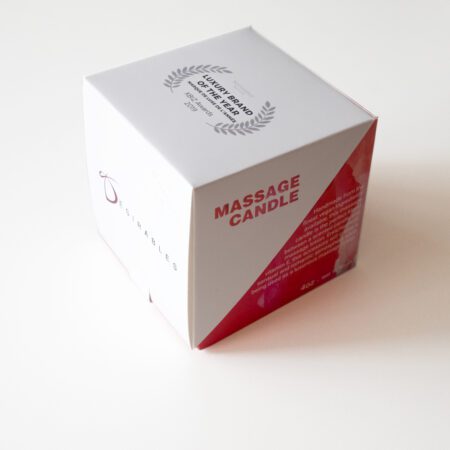 A box containing the Desirables massage candle with massage oil