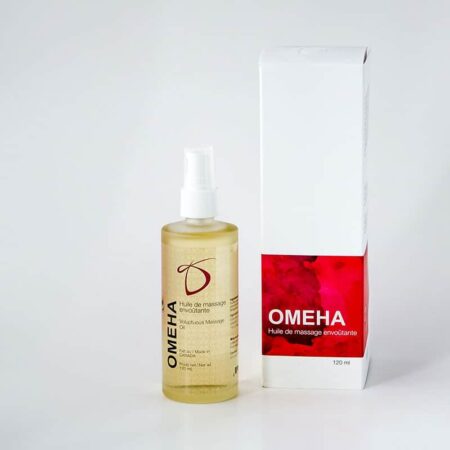A clear container of Desirables Omeha Massage Oil next to a white box