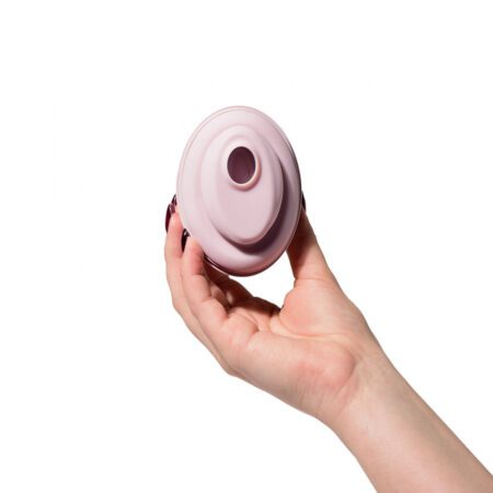 Hand holding the Lori DiCarlo Air Pulse Vibrator