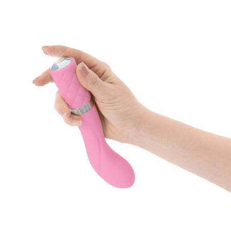 Hand pushing the button of a pink Pillow Talk Sassy g-spot vibrator