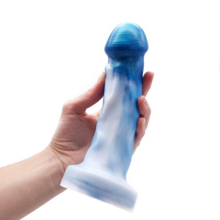 Hand holding a Uberrime Splendid Medium silicone dildo in mermaid pearlÂ 
