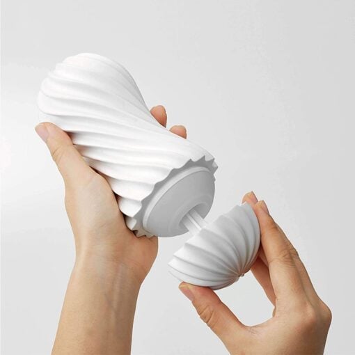 Hands removing the cover from a white Tenga Flex Silky Masturbator