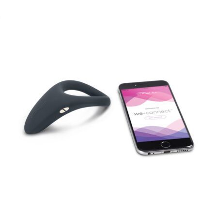 Slate colored We-Vibe Verge cock ring vibrator next to a phone showing the We Connect bluetooth app