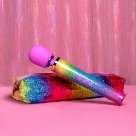 Rainbow colored wand vibrator from Le wand on its bag with a pink background