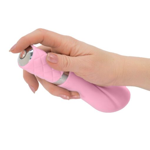 Hand pushing the button of a pink Pillow Talk Sassy g-spot vibrator