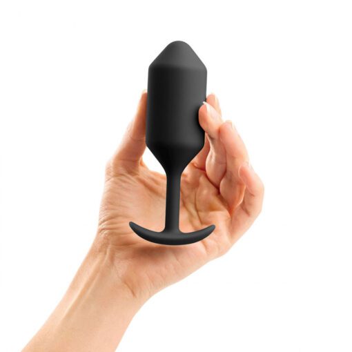 A hand holding the black, large sized B-Vibe Snug plug