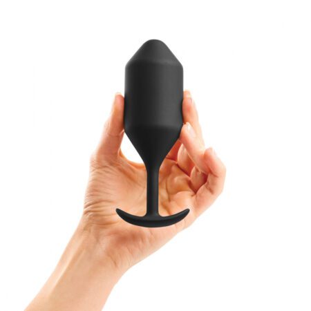 Hand holding a Extra Large Black Snug Plug
