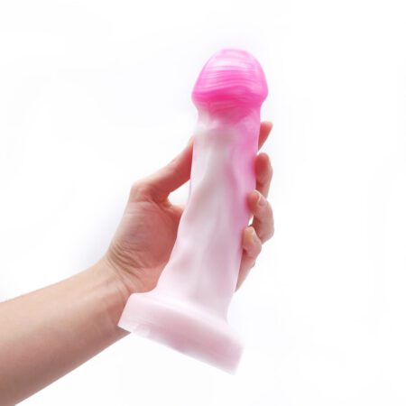 Hand holding a Uberrime Splendid Medium silicone dildo in pink pearlÂ 