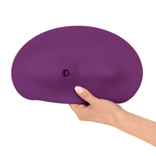 Hand holding the Vibepad 2, sit on vibrator